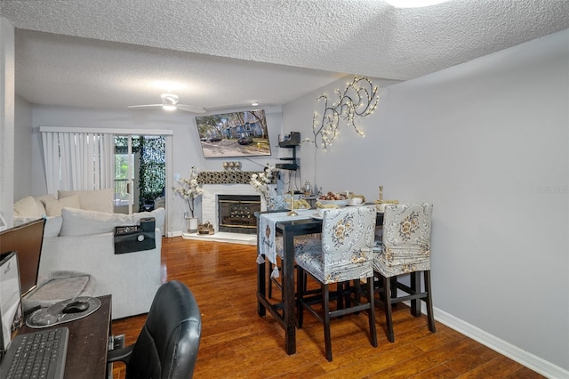 dining area with hardwood / wood-style flooring, a textured ceiling, and ceiling fan