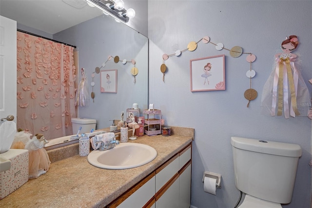 bathroom featuring vanity and toilet