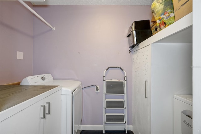 laundry area with washing machine and clothes dryer