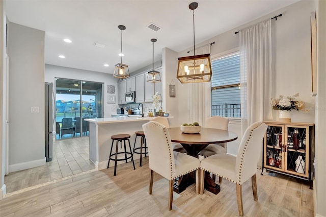 dining room with light hardwood / wood-style floors