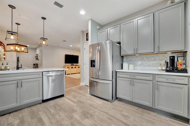 kitchen featuring stainless steel appliances, gray cabinets, and sink