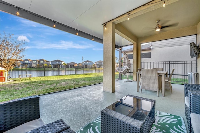 view of patio featuring a water view and ceiling fan