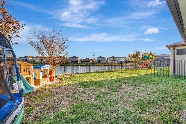 view of yard featuring a water view and a playground