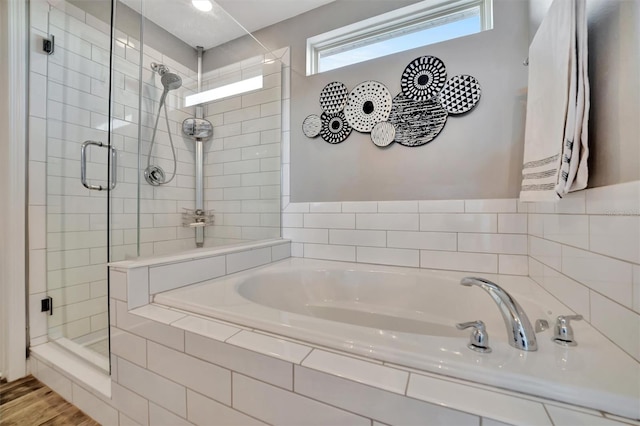 bathroom featuring hardwood / wood-style flooring and separate shower and tub