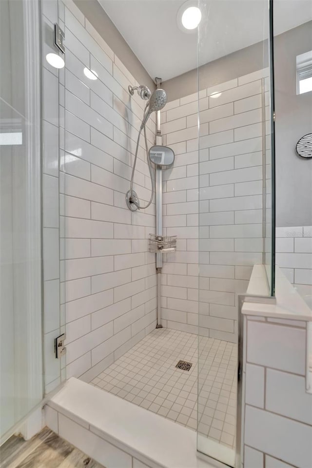 bathroom featuring an enclosed shower and wood-type flooring