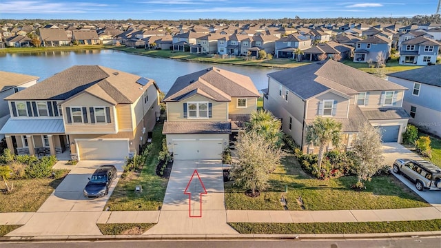 birds eye view of property with a water view