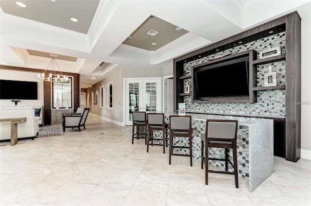 kitchen with french doors, tasteful backsplash, crown molding, hanging light fixtures, and a notable chandelier