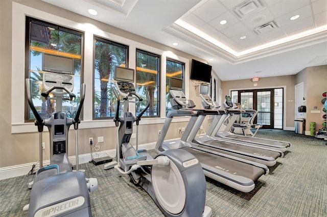 workout area featuring a tray ceiling