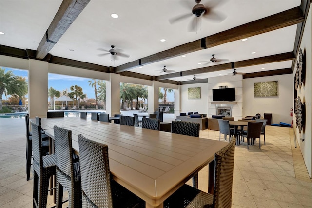 dining space featuring beam ceiling and a wealth of natural light