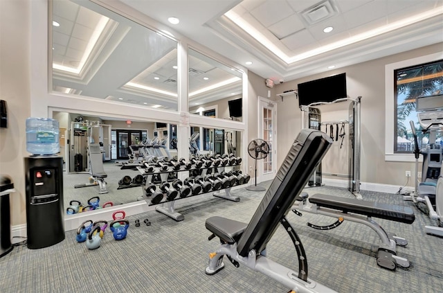 gym with french doors, carpet, and a tray ceiling