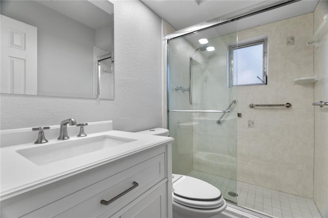 bathroom featuring vanity, toilet, and walk in shower