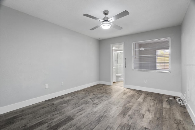 spare room featuring wood-type flooring and ceiling fan