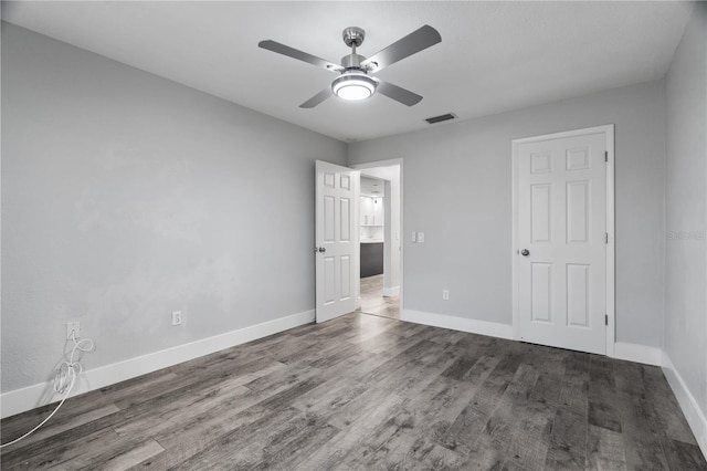 unfurnished bedroom featuring ceiling fan and dark hardwood / wood-style flooring