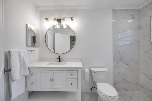 bathroom featuring vanity, toilet, and a tile shower