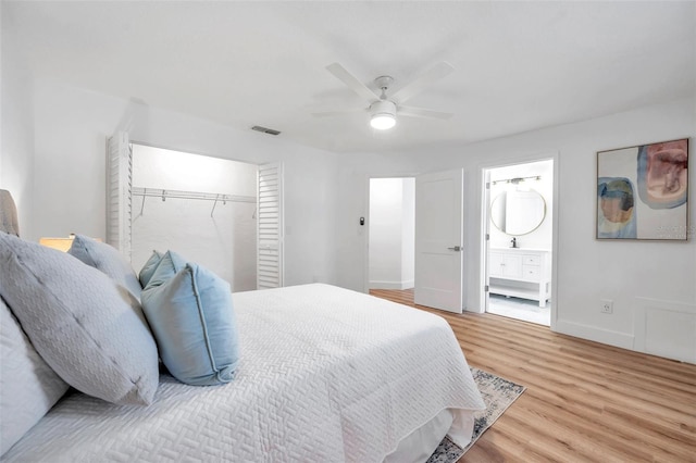 bedroom featuring ceiling fan, connected bathroom, and light hardwood / wood-style floors