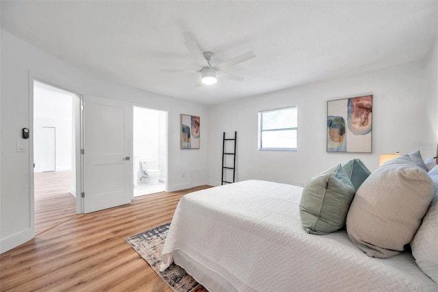 bedroom featuring ceiling fan, ensuite bath, and light hardwood / wood-style floors