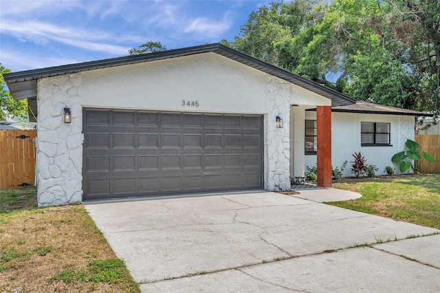 single story home with a garage and a front yard