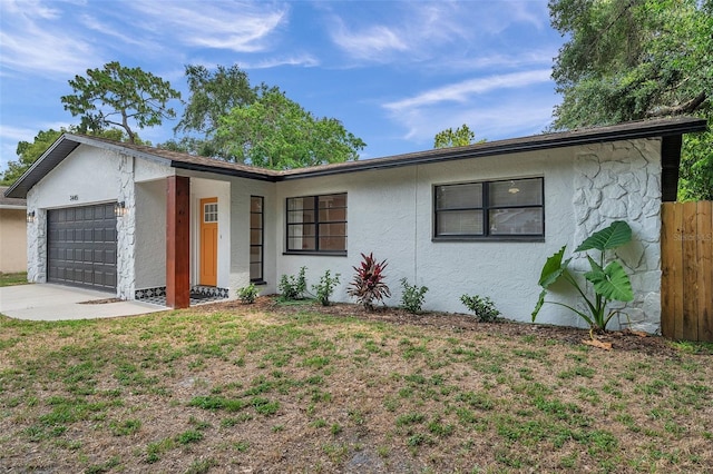 single story home with a garage and a front yard