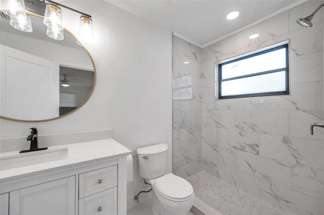 bathroom featuring vanity, toilet, and a tile shower