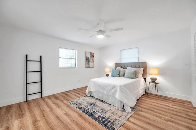 bedroom with ceiling fan and light wood-type flooring