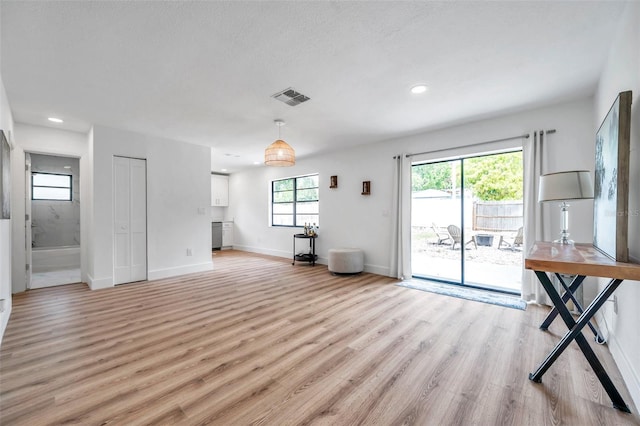 unfurnished living room featuring light hardwood / wood-style floors