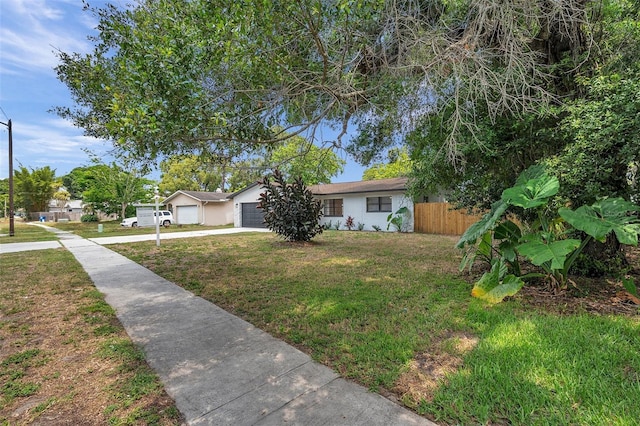 view of front of property with a garage and a front lawn