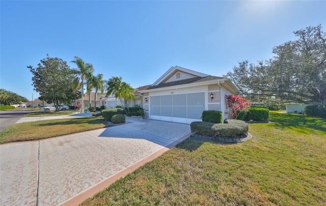 view of front of property featuring an attached garage, a front lawn, decorative driveway, and stucco siding