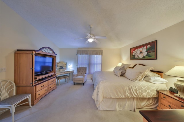 carpeted bedroom featuring ceiling fan, vaulted ceiling, and a textured ceiling