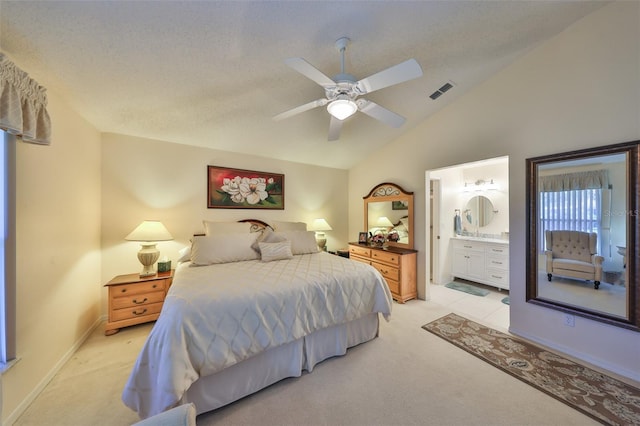 bedroom with lofted ceiling, light carpet, visible vents, and a textured ceiling