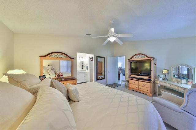 bedroom featuring visible vents, ensuite bathroom, a ceiling fan, light carpet, and vaulted ceiling