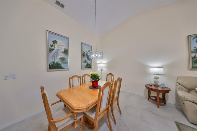 dining room with vaulted ceiling and an inviting chandelier