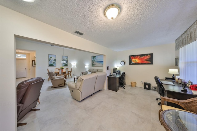 living room featuring visible vents and a textured ceiling