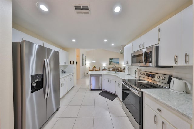 kitchen with backsplash, stainless steel appliances, sink, and white cabinets