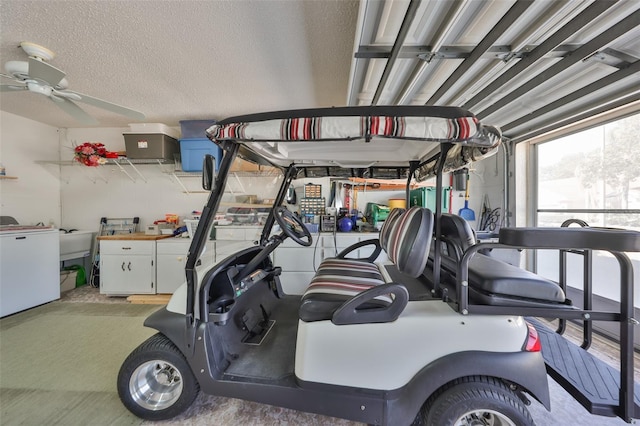 interior space featuring ceiling fan, a sink, and refrigerator