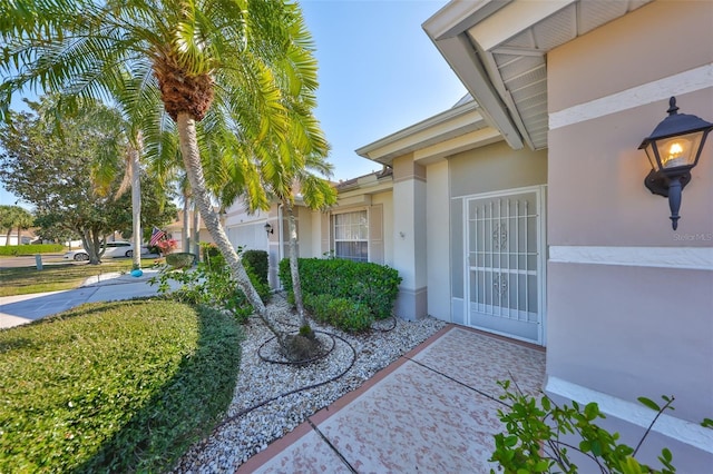 entrance to property with stucco siding