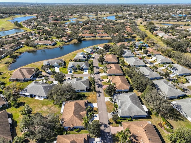 drone / aerial view featuring a water view and a residential view