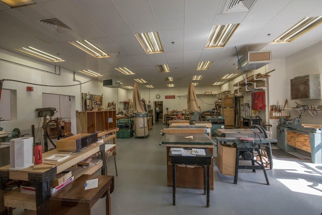 interior space featuring concrete flooring and a workshop area