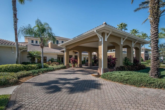 view of community with decorative driveway