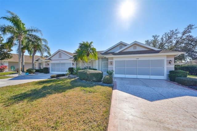 ranch-style house featuring a front yard, concrete driveway, an attached garage, and stucco siding