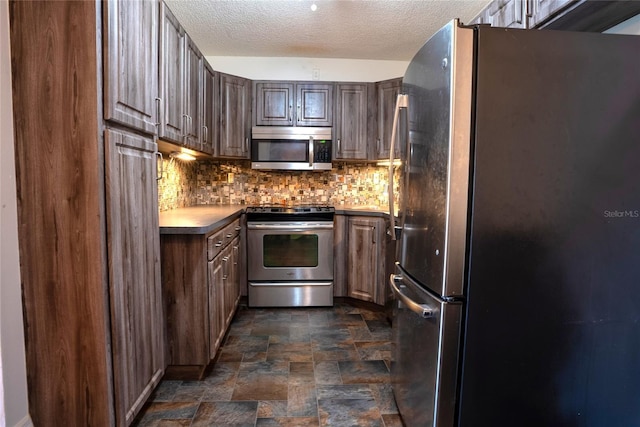 1433 Pine Glen Pl Unit G2, Tarpon Springs, FL 34688 - kitchen featuring backsplash, appliances with stainless steel finishes, a textured ceiling, and stone finish flooring