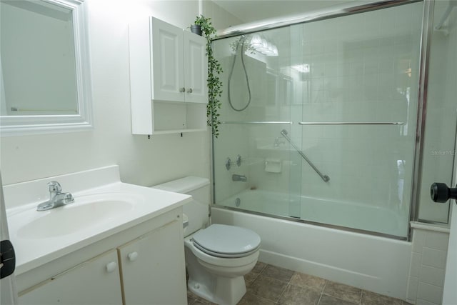 1433 Pine Glen Pl Unit G2, Tarpon Springs, FL 34688 - full bath with vanity, toilet, tile patterned flooring, and bath / shower combo with glass door