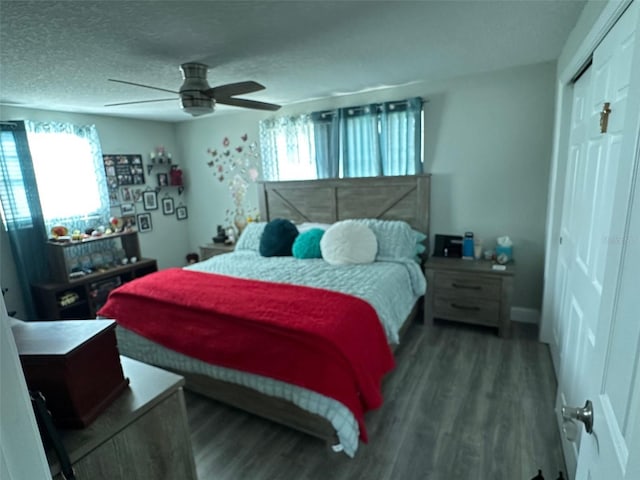 bedroom featuring multiple windows, hardwood / wood-style floors, a closet, and a textured ceiling