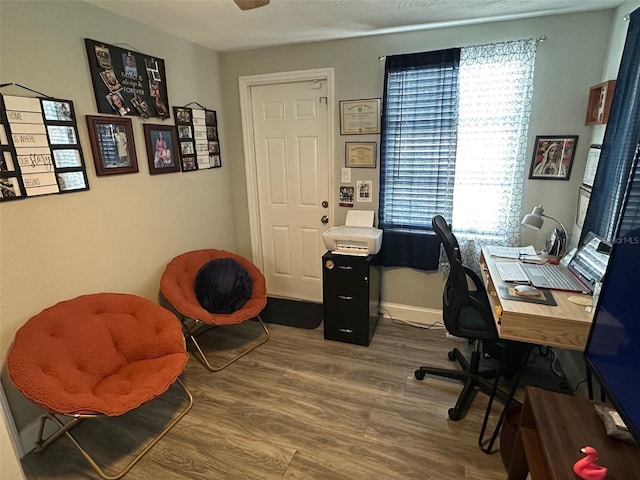 home office with hardwood / wood-style flooring and ceiling fan