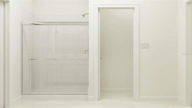 bathroom featuring tile patterned floors and a shower with door