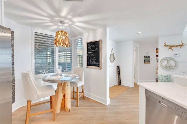 dining space with light hardwood / wood-style flooring