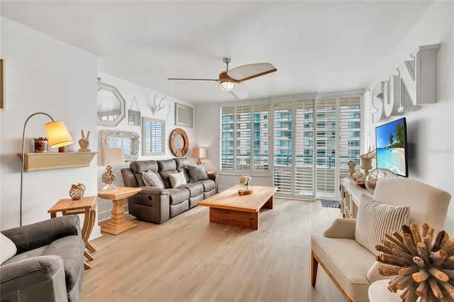 living room featuring ceiling fan and light wood-type flooring