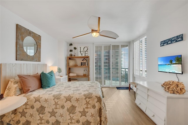 bedroom with ceiling fan, light wood-type flooring, and access to outside