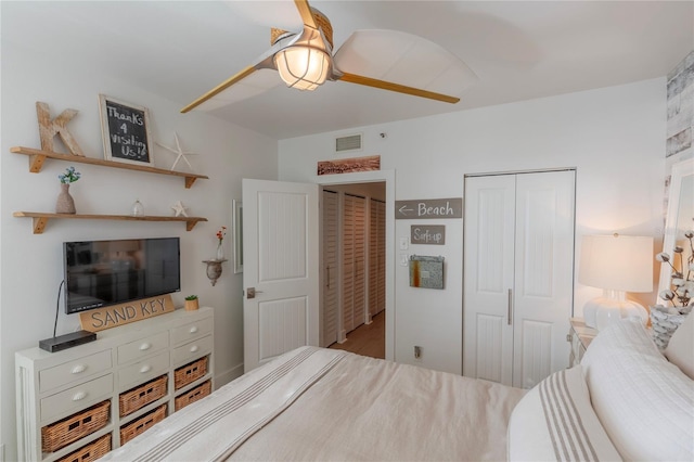 bedroom featuring multiple closets and ceiling fan