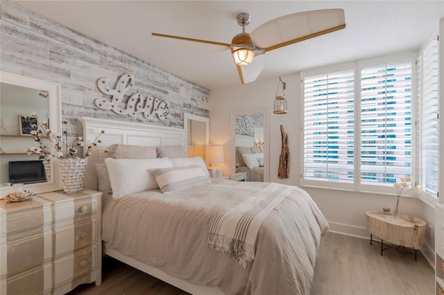 bedroom with ceiling fan and wood-type flooring