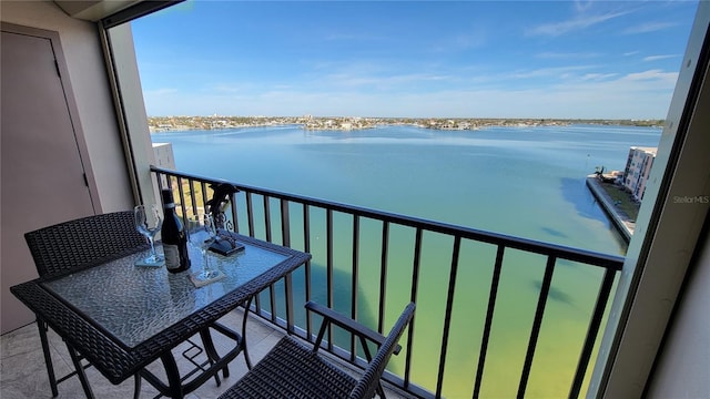 balcony with a water view and a beach view